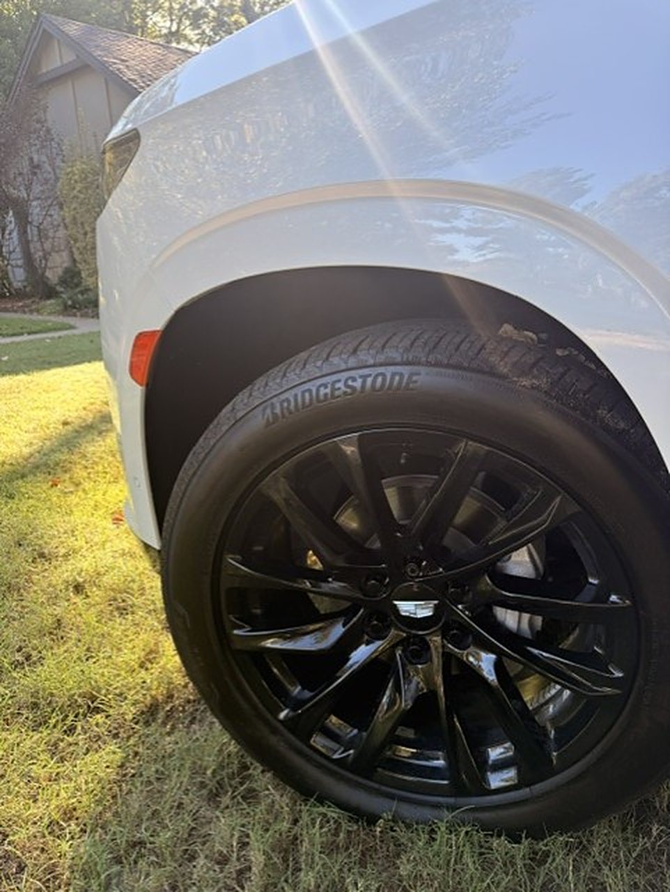 Gloss black wheel on the white Cadillac Escalade