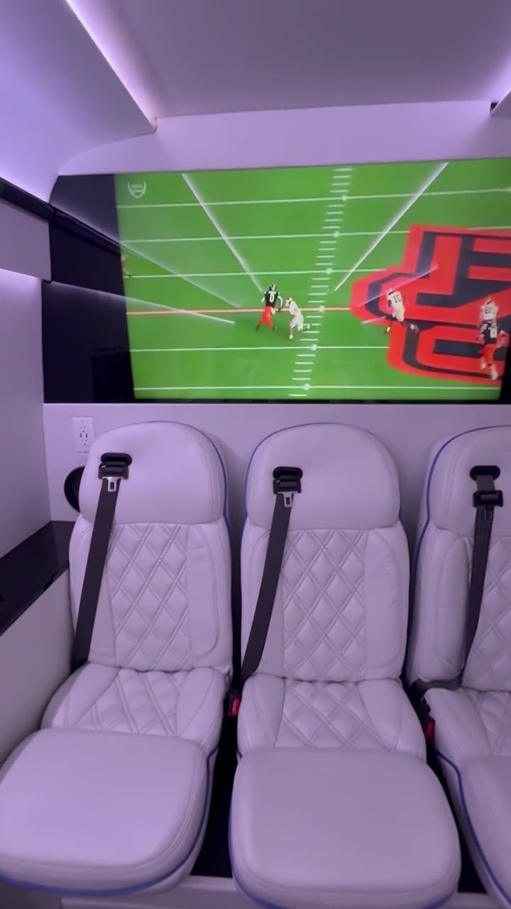Captain's chairs facing the big screens on game day